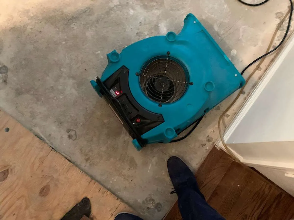 Air mover drying subfloor during Commercial Water Damage Restoration in Beaver Dam